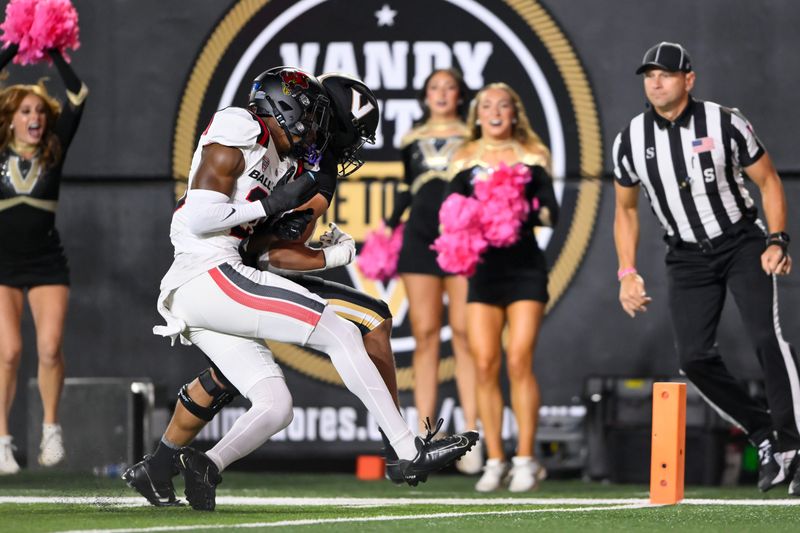 Oct 19, 2024; Nashville, Tennessee, USA;  Vanderbilt Commodores tight end Eli Stowers (9) scores a touchdown as Ball State Cardinals defensive back Willizhuan Yates (20) hits him during the first half at FirstBank Stadium. Mandatory Credit: Steve Roberts-Imagn Images