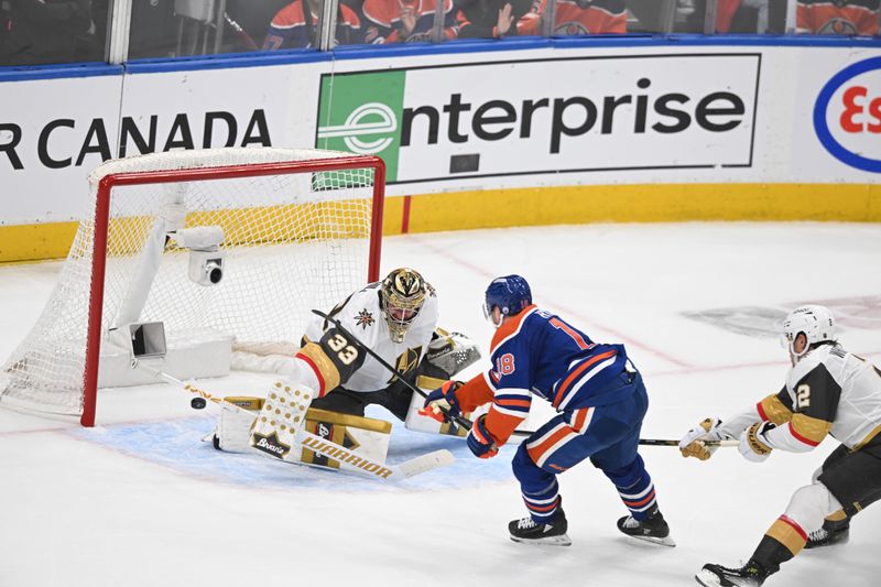 May 12, 2025; Edmonton, Alberta, CAN; Vegas Golden Knights goalie Adin Hill (33) watches for the puck with Edmonton Oilers left winger Zach Hyman (18) during the second period in game three of the second round of the 2025 Stanley Cup Playoffs at Rogers Place. Mandatory Credit: Walter Tychnowicz-Imagn Images