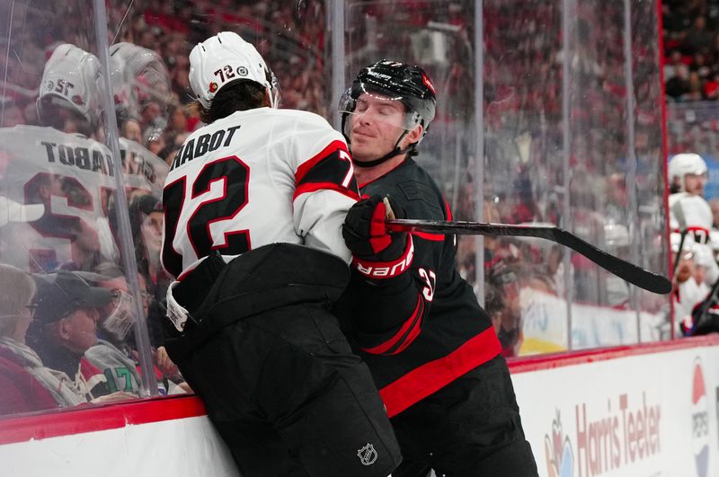 Nov 16, 2024; Raleigh, North Carolina, USA;  Carolina Hurricanes right wing Andrei Svechnikov (37) checks Ottawa Senators defenseman Thomas Chabot (72) during the first period at Lenovo Center. Mandatory Credit: James Guillory-Imagn Images