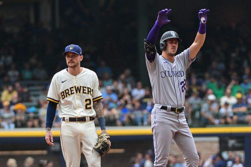 Aug 9, 2023; Milwaukee, Wisconsin, USA;  Colorado Rockies left fielder Nolan Jones (22) reacts after hitting a double to drive in a run in the fourth inning as Milwaukee Brewers second baseman Brice Turang (2) looks on at American Family Field. Mandatory Credit: Benny Sieu-USA TODAY Sports