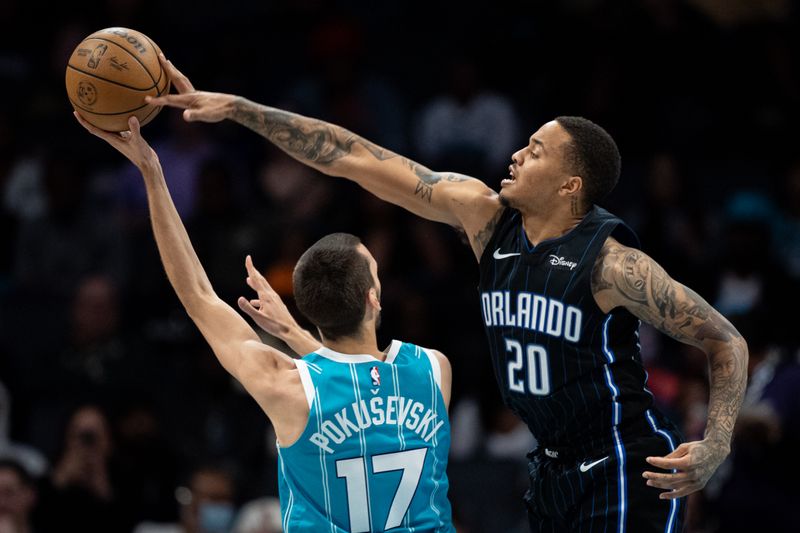 CHARLOTTE, NORTH CAROLINA - APRIL 05: Markelle Fultz #20 of the Orlando Magic blocks a shot from Aleksej Pokusevski #17 of the Charlotte Hornets in the third quarter during their game at Spectrum Center on April 05, 2024 in Charlotte, North Carolina. NOTE TO USER: User expressly acknowledges and agrees that, by downloading and or using this photograph, User is consenting to the terms and conditions of the Getty Images License Agreement. (Photo by Jacob Kupferman/Getty Images)