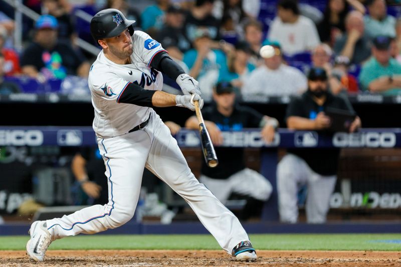 Jun 4, 2023; Miami, Florida, USA; Miami Marlins catcher Jacob Stallings (58) hits a double against the Oakland Athletics during the eighth inning at loanDepot Park. Mandatory Credit: Sam Navarro-USA TODAY Sports