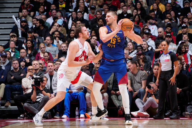 TORONTO, CANADA - OCTOBER 28: Nikola Jokic #15 of the Denver Nuggets handles the ball during the game against the Toronto Raptors on October 28, 2024 at the Scotiabank Arena in Toronto, Ontario, Canada.  NOTE TO USER: User expressly acknowledges and agrees that, by downloading and or using this Photograph, user is consenting to the terms and conditions of the Getty Images License Agreement.  Mandatory Copyright Notice: Copyright 2024 NBAE (Photo by Mark Blinch/NBAE via Getty Images)