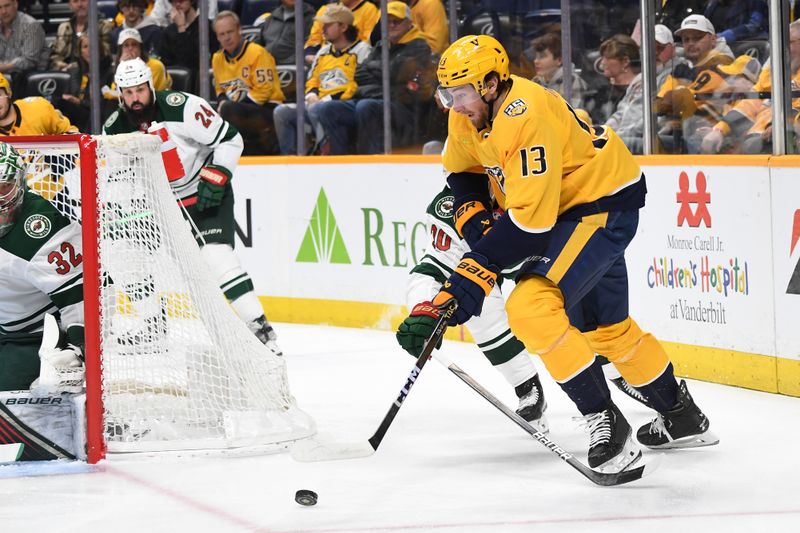 Feb 29, 2024; Nashville, Tennessee, USA; Nashville Predators center Yakov Trenin (13) handles the puck at the side of the net during the first period against the Minnesota Wild at Bridgestone Arena. Mandatory Credit: Christopher Hanewinckel-USA TODAY Sports