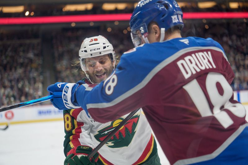 Dec 21, 2025; Saint Paul, Minnesota, USA; Colorado Avalanche center Jack Drury (18) cross checks Minnesota Wild right wing Ryan Hartman (38) in the second period at Grand Casino Arena. Mandatory Credit: Matt Blewett-Imagn Images