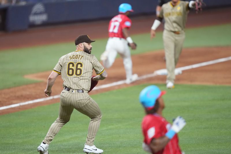 Aug 10, 2024; Miami, Florida, USA;  San Diego Padres pitcher Tanner Scott fields a bunt by Miami Marlins outfielder Cristian Pache (20) in the 10th inning at loanDepot Park. Mandatory Credit: Jim Rassol-USA TODAY Sports