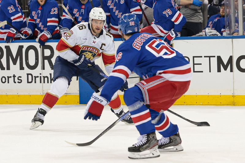 May 24, 2024; New York, New York, USA; Florida Panthers center Aleksander Barkov (16) looks to pass as New York Rangers defenseman Erik Gustafsson (56) defends during the first period in game two of the Eastern Conference Final of the 2024 Stanley Cup Playoffs at Madison Square Garden. Mandatory Credit: Vincent Carchietta-USA TODAY Sports