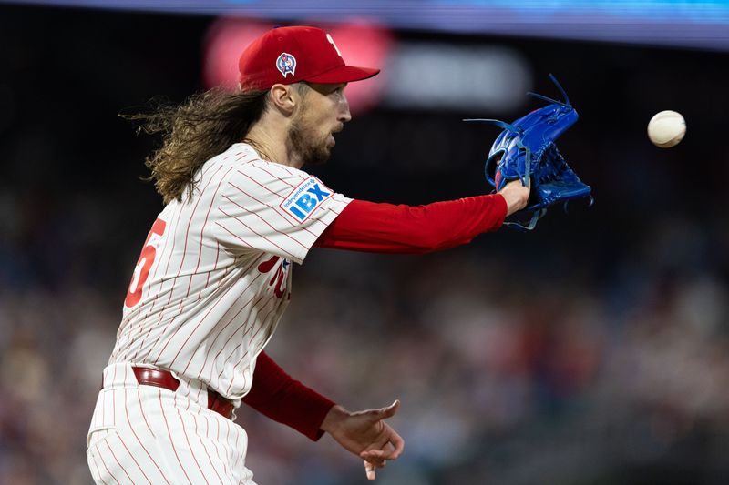 Sep 11, 2024; Philadelphia, Pennsylvania, USA; Philadelphia Phillies pitcher Matt Strahm (25) catches the ball at first bast for an out against the Tampa Bay Rays during the seventh inning at Citizens Bank Park. Mandatory Credit: Bill Streicher-Imagn Images