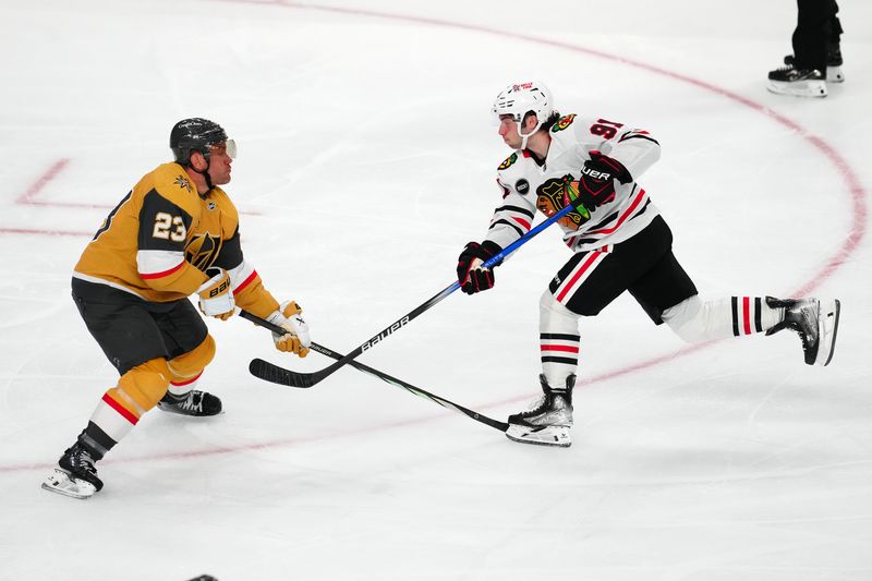 Apr 16, 2024; Las Vegas, Nevada, USA; Chicago Blackhawks center Frank Nazar (91) shoots against Vegas Golden Knights defenseman Alec Martinez (23) during the third period at T-Mobile Arena. Mandatory Credit: Stephen R. Sylvanie-USA TODAY Sports