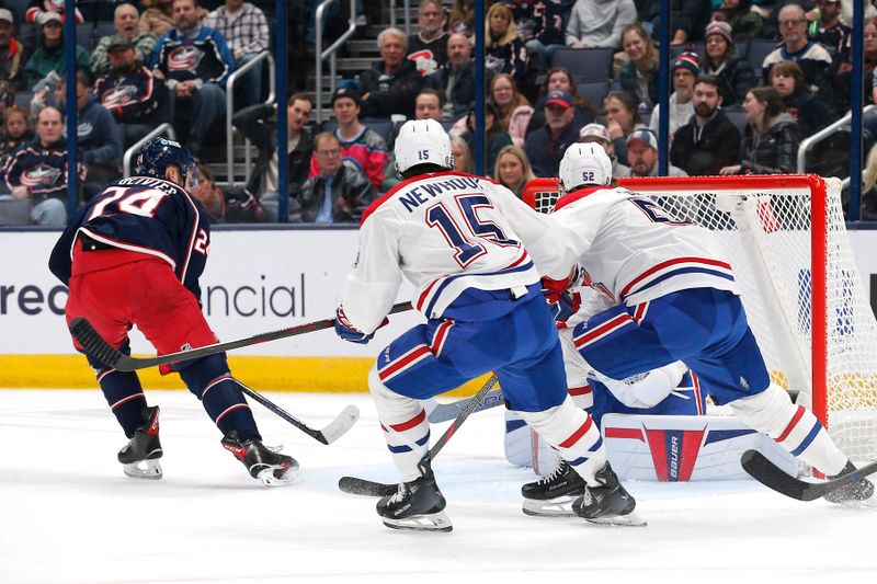 Nov 27, 2024; Columbus, Ohio, USA; Columbus Blue Jackets center Mathieu Olivier (24) flips the puck past Montreal Canadiens goalie Cayden Primeau (30) for a goal during the first period at Nationwide Arena. Mandatory Credit: Russell LaBounty-Imagn Images