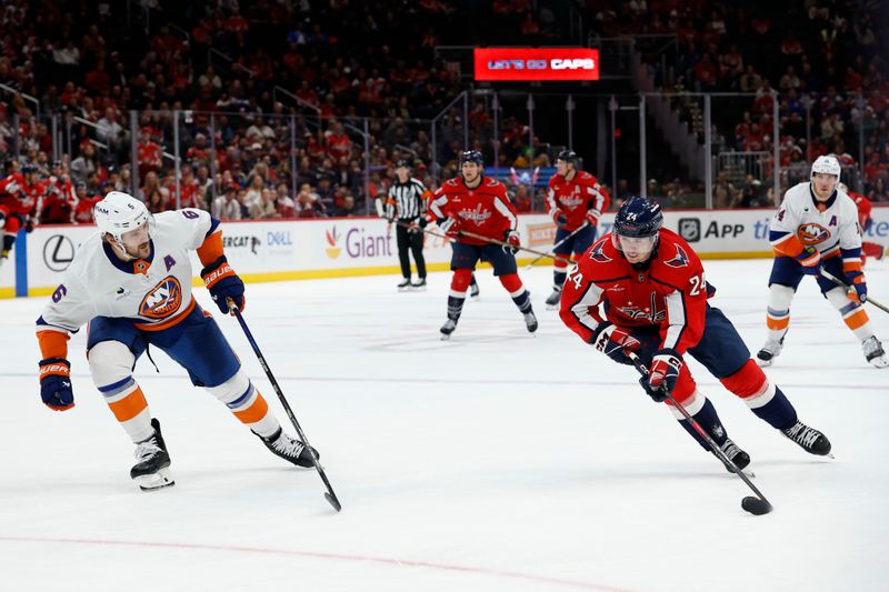 Oct 31, 2025; Washington, District of Columbia, USA; Washington Capitals center Connor McMichael (24) skates with the puck against as New York Islanders defenseman Ryan Pulock (6) defends during the third period at Capital One Arena. Mandatory Credit: Geoff Burke-Imagn Images