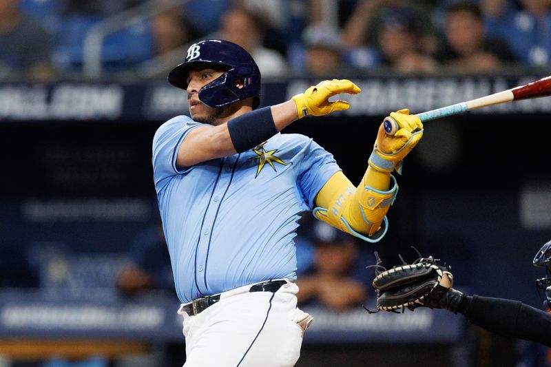 Jun 30, 2024; St. Petersburg, Florida, USA;  Tampa Bay Rays first baseman Isaac Paredes (17) doubles against the Washington Nationals in the sixth inning at Tropicana Field. Mandatory Credit: Nathan Ray Seebeck-USA TODAY Sports