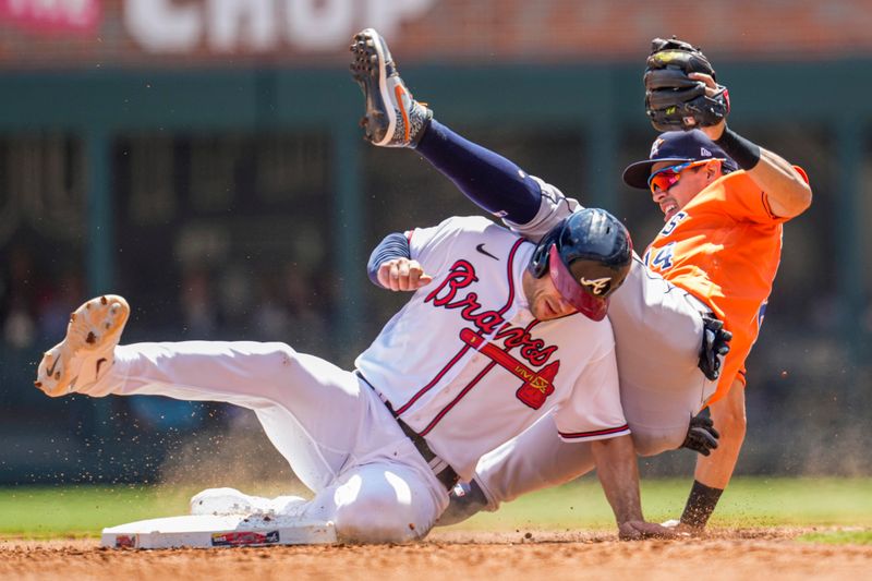 Apr 23, 2023; Cumberland, Georgia, USA; Atlanta Braves first baseman Matt Olson (28) takes out Houston Astros second baseman Mauricio Dubon (14) causing an error on a throw during the sixth inning at Truist Park. Mandatory Credit: Dale Zanine-USA TODAY Sports