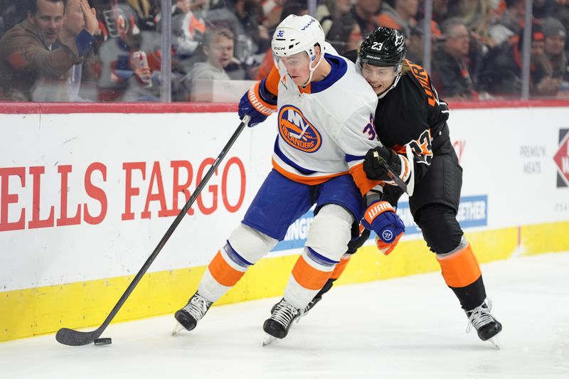 Apr 12, 2025; Philadelphia, Pennsylvania, USA; New York Islanders center Kyle MacLean (32) shields the puck from Philadelphia Flyers left wing Karsen Dorwart (23) in the third period at Wells Fargo Center. Mandatory Credit: Kyle Ross-Imagn Images