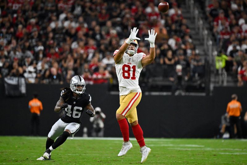 San Francisco 49ers tight end Cameron Latu (81) makes a catch over Las Vegas Raiders cornerback Ja'Quan Sheppard (46) during the first half of an NFL preseason football game, Friday, Aug. 23, 2024, in Las Vegas. (AP Photo/David Becker)