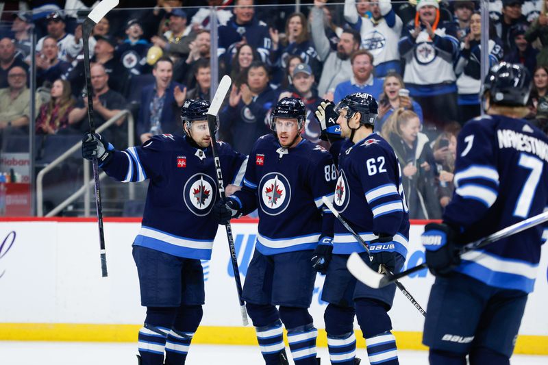 Mar 15, 2024; Winnipeg, Manitoba, CAN; Winnipeg Jets defenseman Nate Schmidt (88) is congratulated by his team mates on his goal against the Anaheim Ducks during the second period at Canada Life Centre. Mandatory Credit: Terrence Lee-USA TODAY Sports