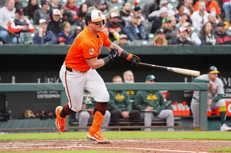 Apr 27, 2024; Baltimore, Maryland, USA; Baltimore Orioles catcher James McCann (27) runs out an RBI single against the Oakland Athletics during the fourth inning at Oriole Park at Camden Yards. Mandatory Credit: Gregory Fisher-USA TODAY Sports