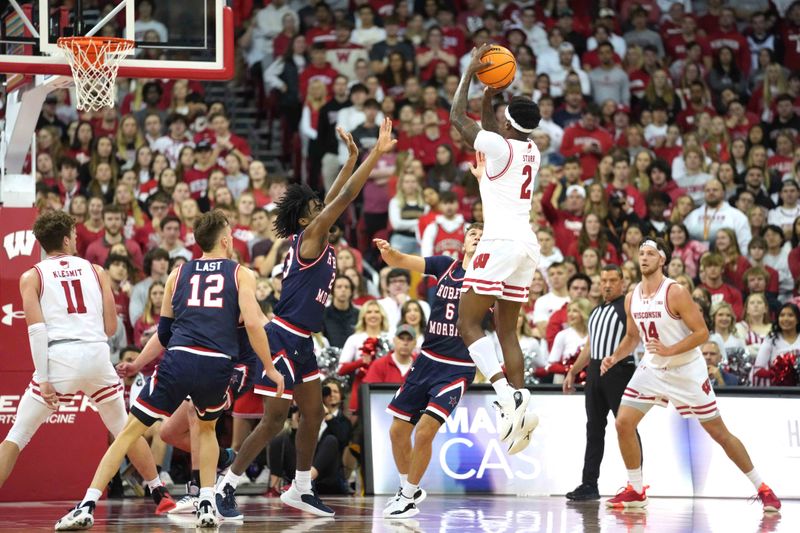 Nov 17, 2023; Madison, Wisconsin, USA; Wisconsin Badgers guard AJ Storr (2) shoots under coverage by Robert Morris Colonials guard Chris Ford (23) during the first half at the Kohl Center. Mandatory Credit: Kayla Wolf-USA TODAY Sports