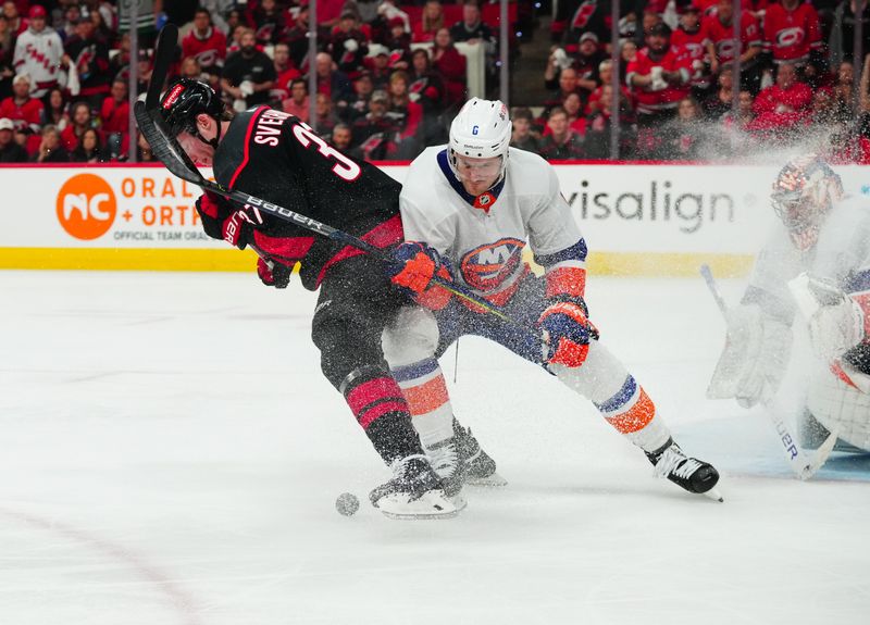 Apr 20, 2024; Raleigh, North Carolina, USA; New York Islanders defenseman Ryan Pulock (6) and Carolina Hurricanes right wing Andrei Svechnikov (37) battle over the puck in front of the net during the third period in game one of the first round of the 2024 Stanley Cup Playoffs at PNC Arena. Mandatory Credit: James Guillory-USA TODAY Sports