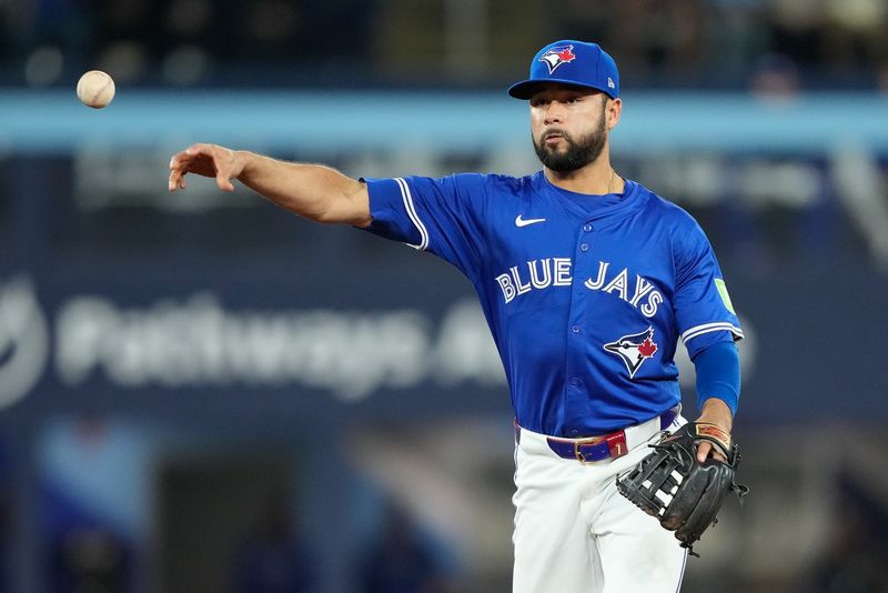 Apr 14, 2024; Toronto, Ontario, CAN; Toronto Blue Jays second baseman Isiah Kiner-Falefa (7) throws out Colorado Rockies left fielder Nolan Jones (not pictured) during the sixth inning at Rogers Centre. Mandatory Credit: John E. Sokolowski-USA TODAY Sports