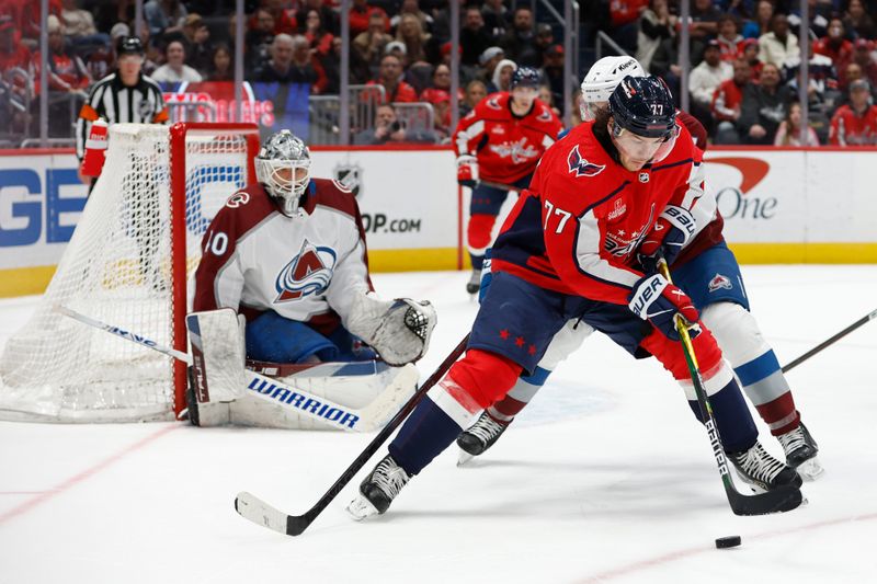 Feb 13, 2024; Washington, District of Columbia, USA; Washington Capitals right wing T.J. Oshie (77) controls the puck as Colorado Avalanche defenseman Devon Toews (7) defends in the third period at Capital One Arena. Mandatory Credit: Geoff Burke-USA TODAY Sports