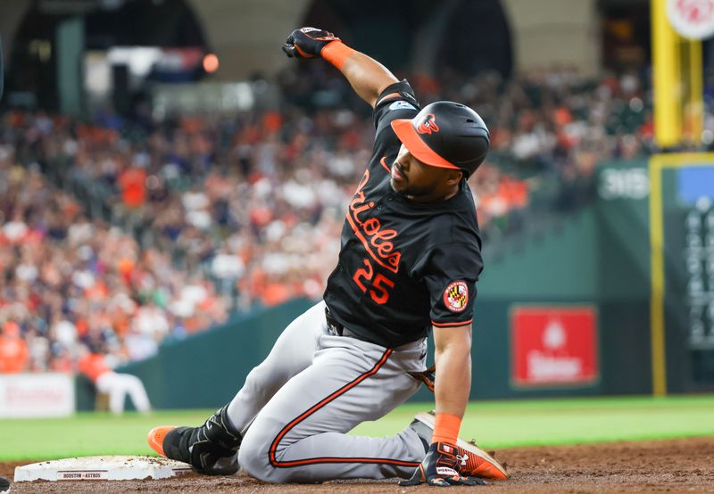 Jun 21, 2024; Houston, Texas, USA; Baltimore Orioles right fielder Anthony Santander (25) reaches back to first base after hitting a RBI single against the Houston Astros in the third inning at Minute Maid Park. Mandatory Credit: Thomas Shea-USA TODAY Sports
