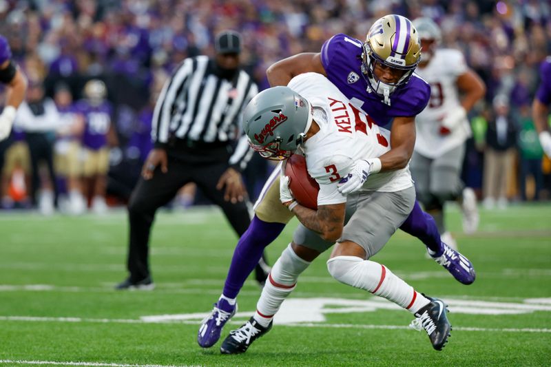 Nov 25, 2023; Seattle, Washington, USA; Washington Huskies cornerback Jabbar Muhammad (1) tackles Washington State Cougars wide receiver Josh Kelly (3) during the fourth quarter at Alaska Airlines Field at Husky Stadium. Mandatory Credit: Joe Nicholson-USA TODAY Sports