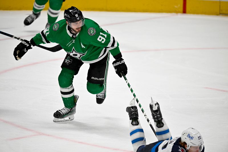 Apr 11, 2024; Dallas, Texas, USA; Dallas Stars center Tyler Seguin (91) is called for tripping on Winnipeg Jets center Mason Appleton (22) during the third period at the American Airlines Center. Mandatory Credit: Jerome Miron-USA TODAY Sports