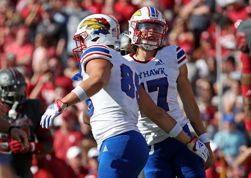 Oct 15, 2022; Norman, Oklahoma, USA;  Kansas Jayhawks quarterback Jason Bean (17) celebrates with Kansas Jayhawks tight end Mason Fairchild (89) after a touchdown during the first half against the Oklahoma Sooners at Gaylord Family-Oklahoma Memorial Stadium. Mandatory Credit: Kevin Jairaj-USA TODAY Sports