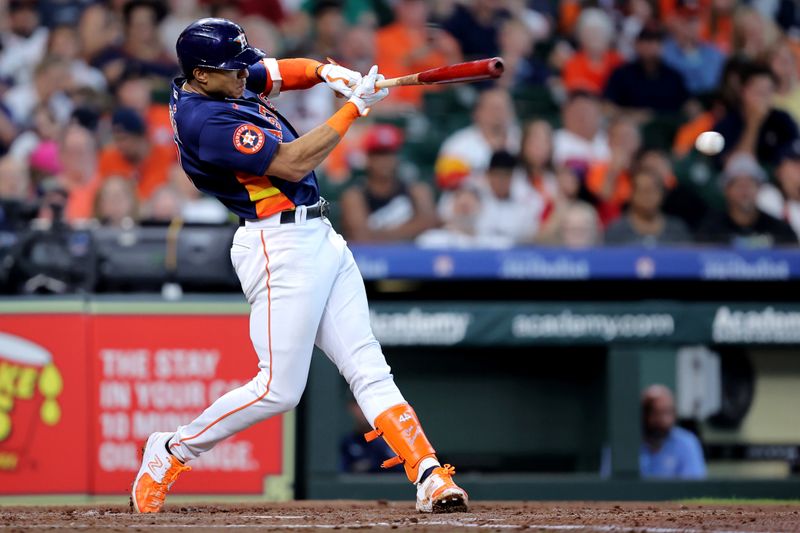 Jul 30, 2023; Houston, Texas, USA; Houston Astros shortstop Jeremy Pena (3) hits a single up the middle against the Tampa Bay Rays during the third inning at Minute Maid Park. Mandatory Credit: Erik Williams-USA TODAY Sports