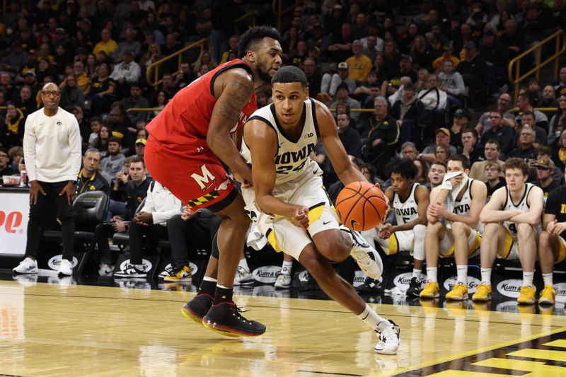 Jan 15, 2023; Iowa City, Iowa, USA; Iowa Hawkeyes forward Kris Murray (24) drives past Maryland Terrapins forward Donta Scott (24) at Carver-Hawkeye Arena.  The Hawkeyes beat the Terrapins 81-67. Mandatory Credit: Reese Strickland-USA TODAY Sports