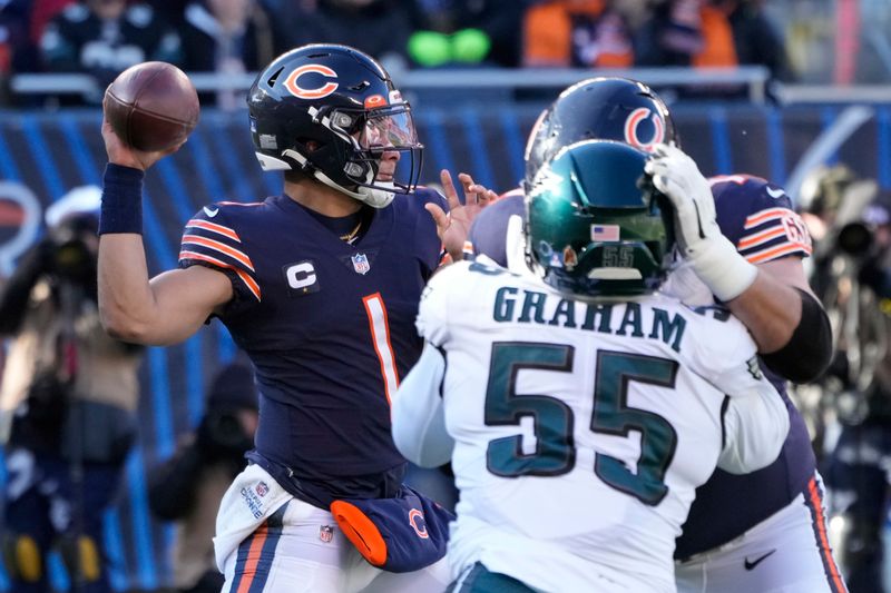 Chicago Bears' Justin Fields passes during the first half of an NFL football game against the Philadelphia Eagles, Sunday, Dec. 18, 2022, in Chicago. (AP Photo/Charles Rex Arbogast)