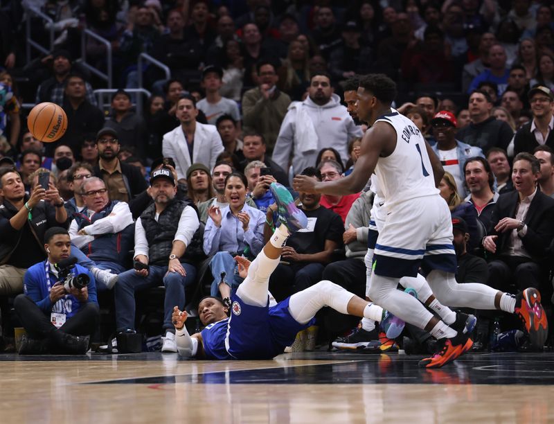 LOS ANGELES, CALIFORNIA - FEBRUARY 28: Russell Westbrook #0 of the LA Clippers watches the ball as he falls in front of Anthony Edwards #1 of the Minnesota Timberwolves during a 108-101 Timberwolves win at Crypto.com Arena on February 28, 2023 in Los Angeles, California. NOTE TO USER: User expressly acknowledges and agrees that, by downloading and or using this photograph, user is consenting to the terms and conditions of the Getty Images License Agreement. (Photo by Harry How/Getty Images)