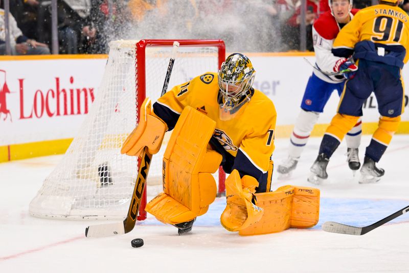 Mar 28, 2026; Nashville, Tennessee, USA;  Nashville Predators goaltender Juuse Saros (74) blocks the shot of Montreal Canadiens center Alex Newhook (15) during the second period Gat Bridgestone Arena. Mandatory Credit: Steve Roberts-Imagn Images