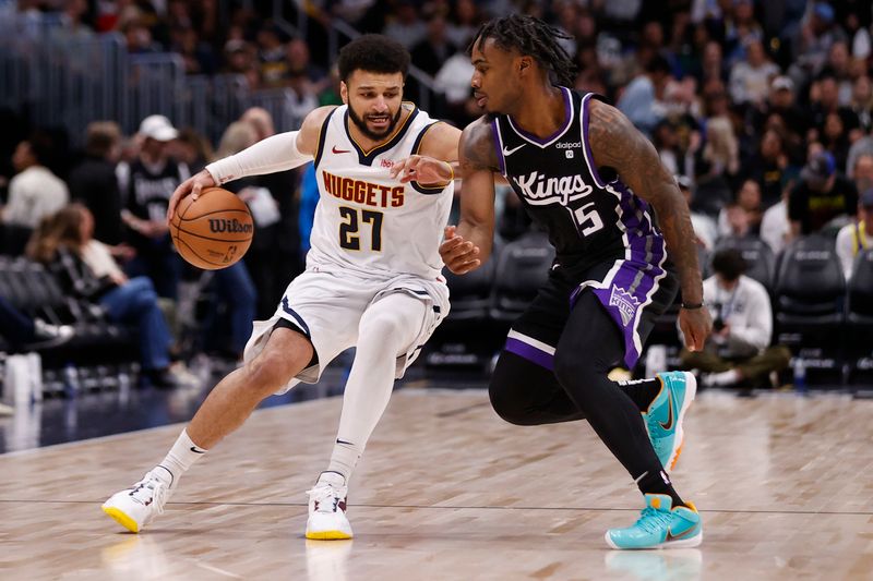 DENVER, COLORADO - FEBRUARY 28: Jamal Murray #27 of the Denver Nuggets brings the ball up court against Davion Mitchell #15 of the Sacramento Kings at Ball Arena on February 28, 2024 in Denver, Colorado. NOTE TO USER: User expressly acknowledges and agrees that, by downloading and or using this photograph, User is consenting to the terms and conditions of the Getty Images License Agreement. (Photo by Brendall O'Banon/Clarkson Creative/Getty Images)