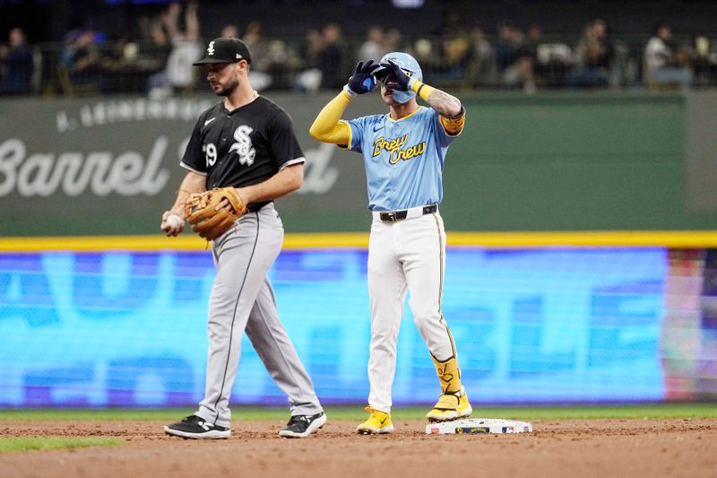 May 31, 2024; Milwaukee, Wisconsin, USA;  Milwaukee Brewers third baseman Joey Ortiz (3) celebrates at second base after driving in a run during the second inning against the Chicago White Sox at American Family Field. Mandatory Credit: Jeff Hanisch-USA TODAY Sports