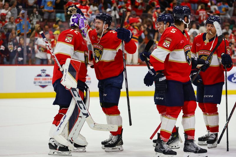 Nov 7, 2024; Sunrise, Florida, USA; Florida Panthers defenseman Uvis Balinskis (26) celebrates with goaltender Sergei Bobrovsky (72) after the game against the Nashville Predators at Amerant Bank Arena. Mandatory Credit: Sam Navarro-Imagn Images