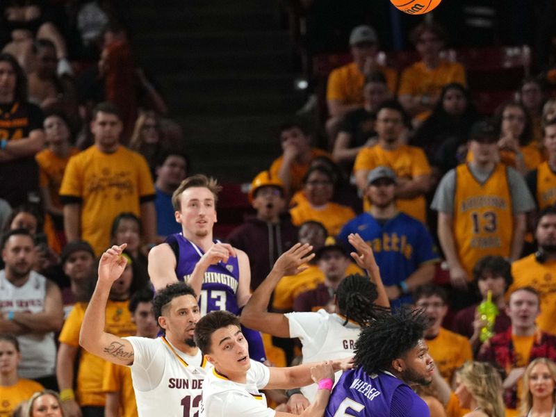 Feb 22, 2024; Tempe, Arizona, USA; Arizona State Sun Devils guard Bobby Hurley (11) and Washington Huskies guard Sahvir Wheeler (5) go after a loose ball during the second half at Desert Financial Arena. Mandatory Credit: Joe Camporeale-USA TODAY Sports