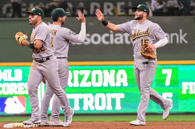 Jun 11, 2023; Milwaukee, Wisconsin, USA; Oakland Athletes left fielder Seth Brown (15) celebrates with shortstop Kevin Smith (4) after sweeping the Milwaukee Brewers at American Family Field. Mandatory Credit: Benny Sieu-USA TODAY Sports