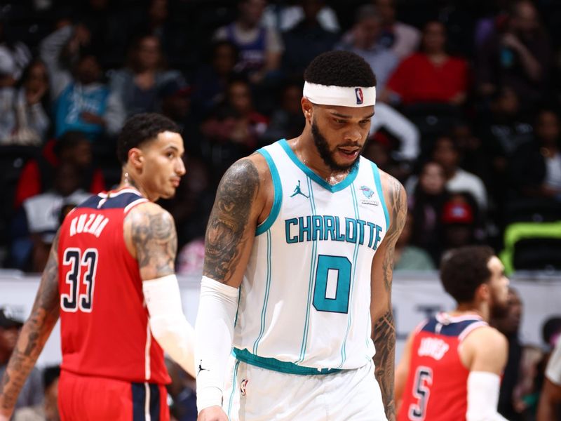 WASHINGTON, DC -? MARCH 8: Miles Bridges #0 of the Charlotte Hornets and Kyle Kuzma #33 of the Washington Wizards walk towards the bench to enter a timeout during the game on March 8, 2024 at Capital One Arena in Washington, DC. NOTE TO USER: User expressly acknowledges and agrees that, by downloading and or using this Photograph, user is consenting to the terms and conditions of the Getty Images License Agreement. Mandatory Copyright Notice: Copyright 2024 NBAE (Photo by Kenny Giarla/NBAE via Getty Images)