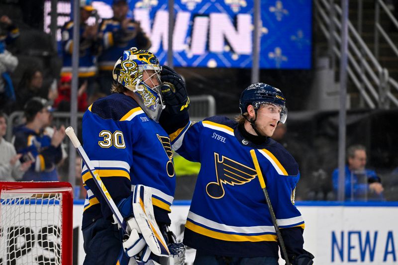 Apr 10, 2024; St. Louis, Missouri, USA;  St. Louis Blues defenseman Scott Perunovich (48) celebrates with goaltender Joel Hofer (30) after the Blues defeated the Chicago Blackhawks at Enterprise Center. Mandatory Credit: Jeff Curry-USA TODAY Sports