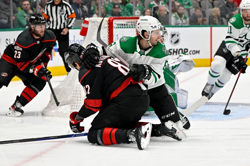 Jan 25, 2023; Dallas, Texas, USA; Dallas Stars defenseman Colin Miller (6) takes down Carolina Hurricanes center Jesperi Kotkaniemi (82) during the first period at the American Airlines Center. Mandatory Credit: Jerome Miron-USA TODAY Sports