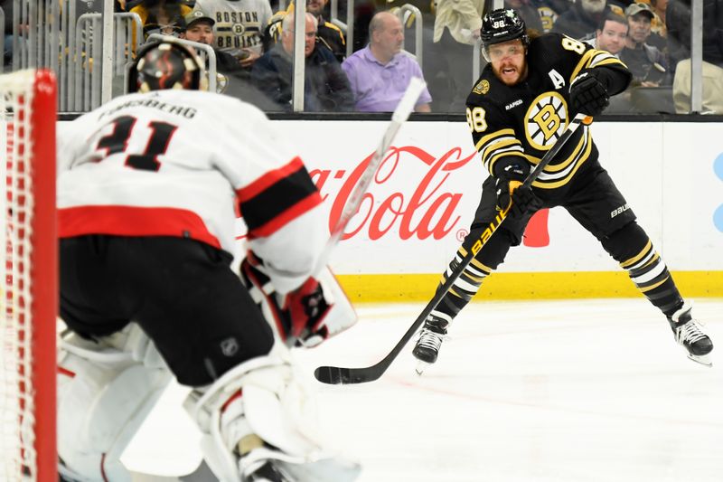 Apr 16, 2024; Boston, Massachusetts, USA;  Boston Bruins right wing David Pastrnak (88) pass the puck during the first period against the Ottawa Senators at TD Garden. Mandatory Credit: Bob DeChiara-USA TODAY Sports