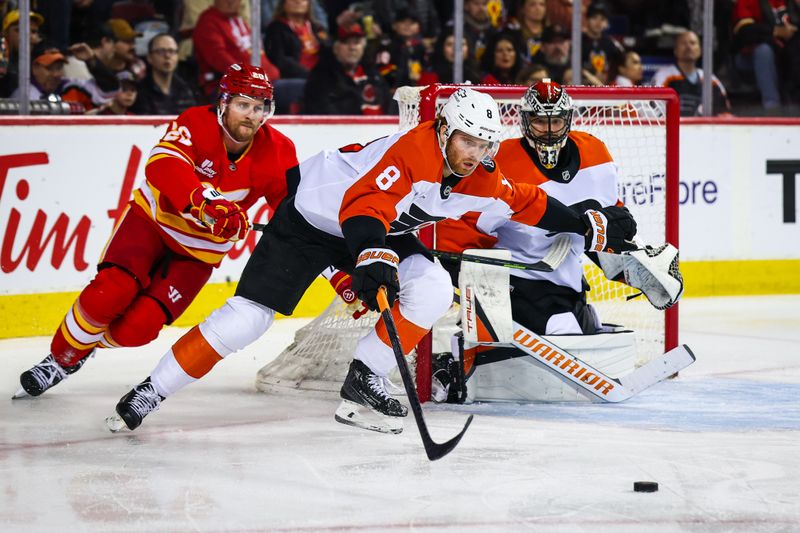 Dec 31, 2025; Calgary, Alberta, CAN; Philadelphia Flyers defenseman Cam York (8) controls the puck against Calgary Flames left wing Blake Coleman (20) in front of Philadelphia Flyers goaltender Samuel Ersson (33) during the second period at Scotiabank Saddledome. Mandatory Credit: Sergei Belski-Imagn Images