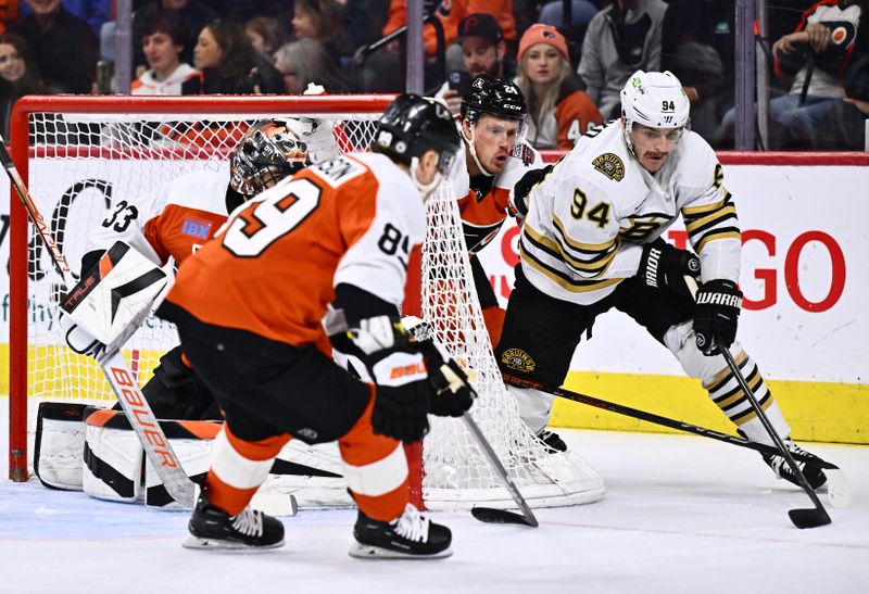 Jan 27, 2024; Philadelphia, Pennsylvania, USA; Boston Bruins center Jakub Lauko (94) pushes the puck past Philadelphia Flyers defenseman Nick Seeler (24) in the first period at Wells Fargo Center. Mandatory Credit: Kyle Ross-USA TODAY Sports