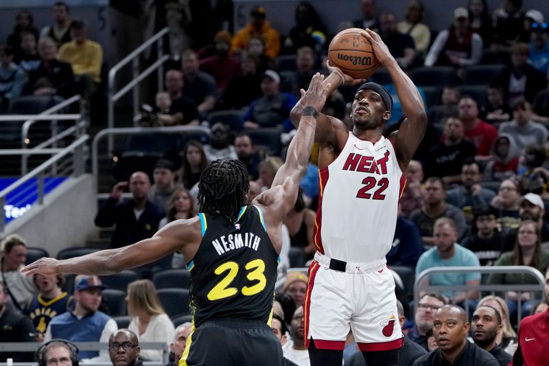 INDIANAPOLIS, INDIANA - APRIL 07: Jimmy Butler #22 of the Miami Heat attempts a shot while being guarded by Aaron Nesmith #23 of the Indiana Pacers in the first quarter at Gainbridge Fieldhouse on April 07, 2024 in Indianapolis, Indiana. NOTE TO USER: User expressly acknowledges and agrees that, by downloading and or using this photograph, User is consenting to the terms and conditions of the Getty Images License Agreement. (Photo by Dylan Buell/Getty Images)