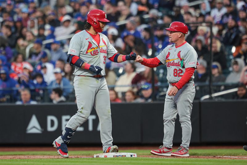 Apr 26, 2024; New York City, New York, USA;  St. Louis Cardinals shortstop Brandon Crawford (35) fist bumps with first base coach Stubby Clapp (82) after a single during the second inning against the New York Mets at Citi Field. Mandatory Credit: Vincent Carchietta-USA TODAY Sports