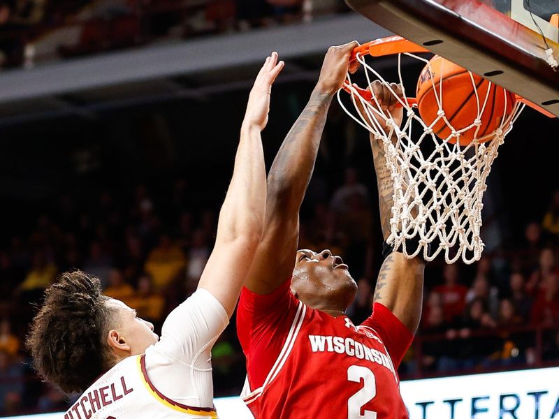 Jan 23, 2024; Minneapolis, Minnesota, USA; Wisconsin Badgers guard AJ Storr (2) dunks as Minnesota Golden Gophers guard Mike Mitchell Jr. (2) defends during the second half at Williams Arena. Mandatory Credit: Matt Krohn-USA TODAY Sports