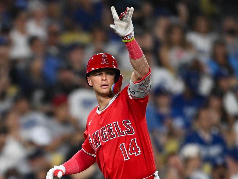 Jun 22, 2024; Los Angeles, California, USA; Los Angeles Angels catcher Logan O'Hoppe (14) celebrates after hitting a home run against the Los Angeles Dodgers during the seventh inning at Dodger Stadium. Mandatory Credit: Jonathan Hui-USA TODAY Sports