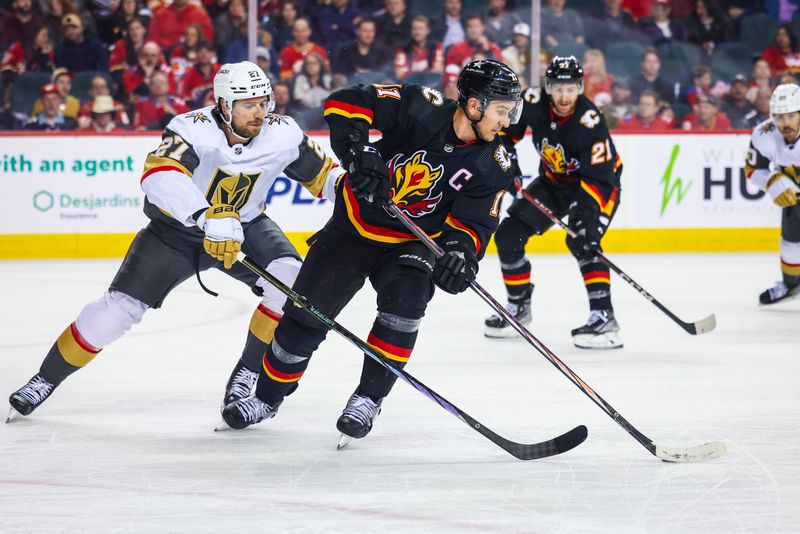 Mar 14, 2024; Calgary, Alberta, CAN; Calgary Flames center Mikael Backlund (11) controls the puck against Vegas Golden Knights defenseman Shea Theodore (27) during the second period at Scotiabank Saddledome. Mandatory Credit: Sergei Belski-USA TODAY Sports